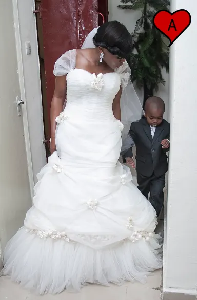 Bride in her wedding dress with her flower boy